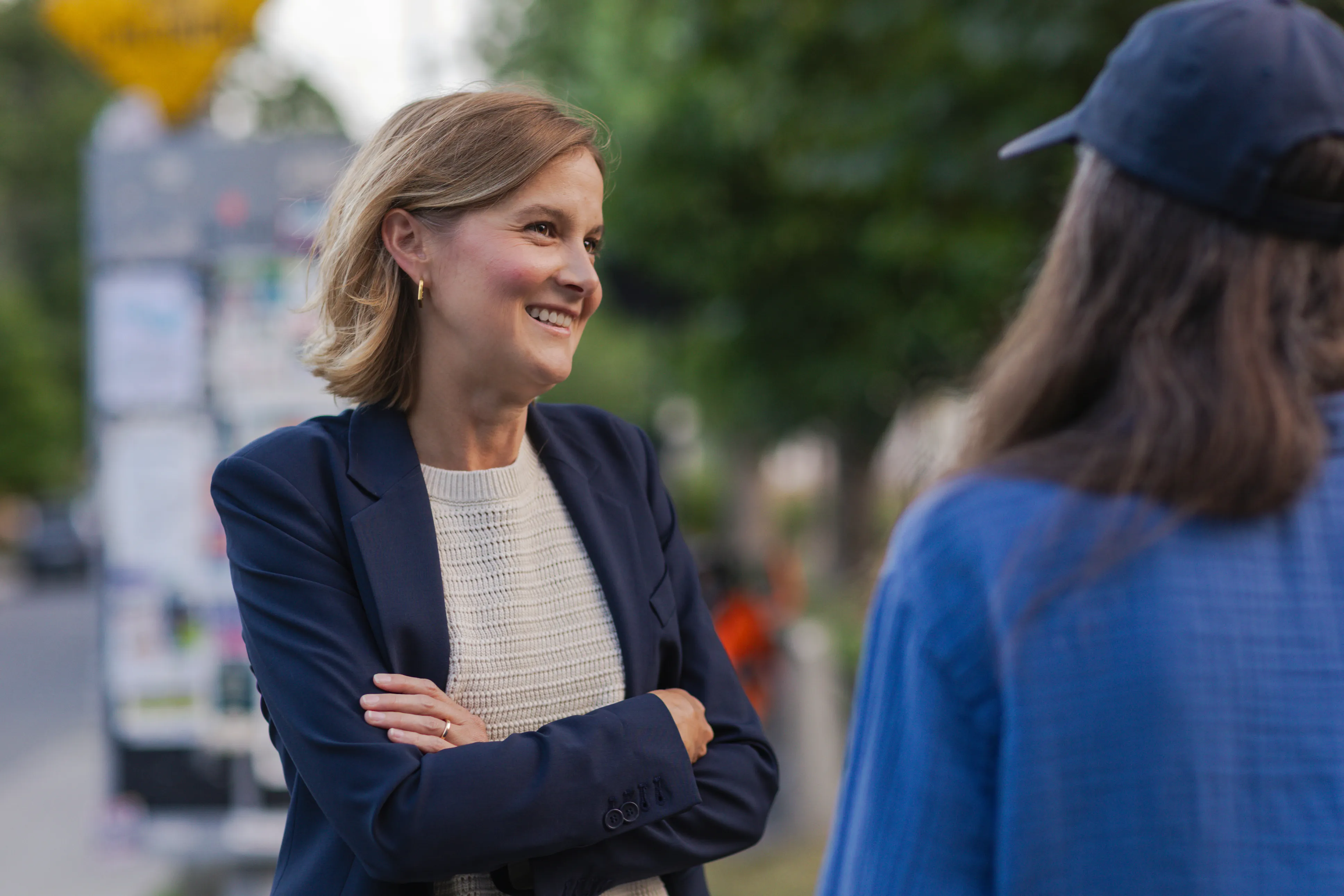 Laura Dean in conversation with a resident on a Toronto sidewalk
